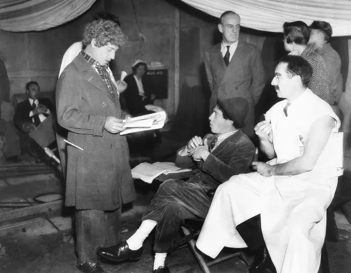 Framed Print : Harpo, Chico and Groucho Marx on the set of MGM's movie, A DAY AT THE RACES. Oct. 8, 1937. Director Sam Wood standing in right background