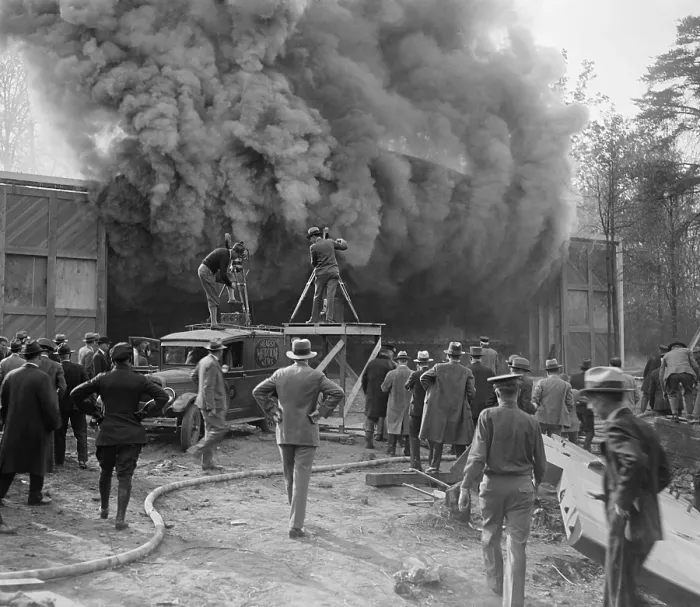 Framed Print : Hearst Movietone cameramen film a fire in Washington, D.C. in c. 1920. One man stands on the roof of his truck as dense smokes pours from a building (BSLOC_2016_8_156) Framed Print : Hearst Movietone cameramen film a fire in Washington, D.C. in c. 1920. One man stands on the roof of his truck as dense smokes pours from a building (BSLOC_2016_8_156)