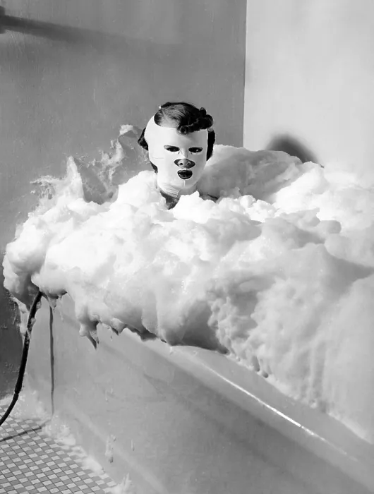 Framed Print : Helena Rubenstein Fifth Avenue Salon. Client in a bath of milk treated with compressed air to provide bubbles. The mask is a special device for restoring youthful contours