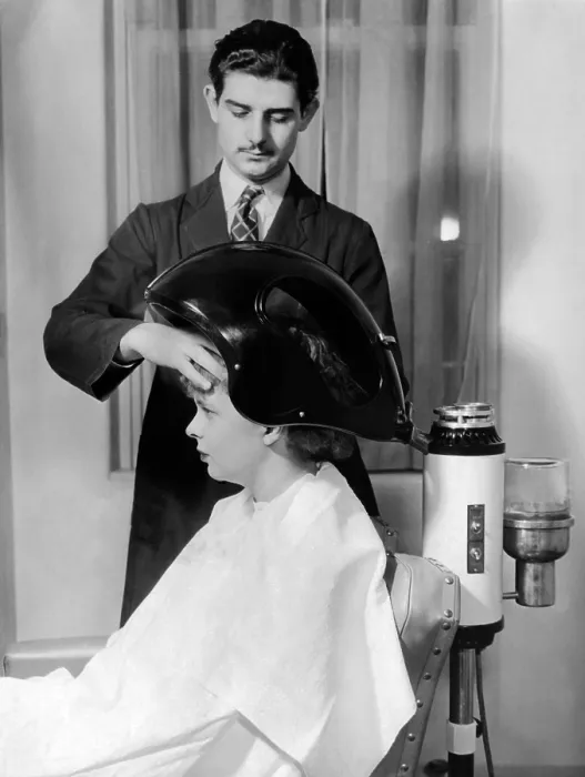 Framed Print : Helena Rubenstein Fifth Avenue Salon. Client under the scalp steamer where balsam oil forced into the scalp and hair. It helps make permanent curls soft and brilliant. March 1937