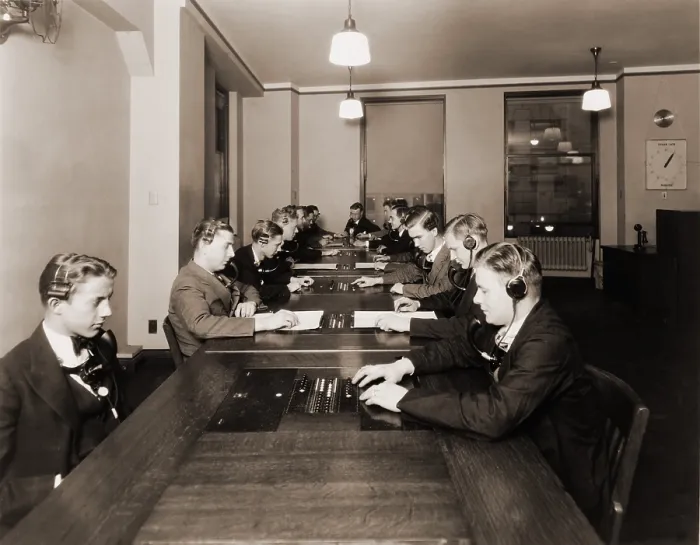 Framed Print : High technology in 1928 was the NY Stock Exchange's new quotation system. Photo shows men with headphones and mouthpieces working in the new quotation room