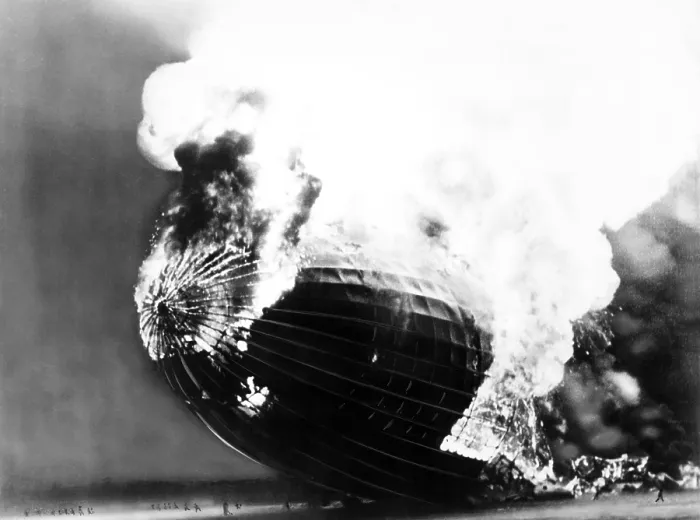 Framed Print : The Hindenburg disaster. People run away from the burning dirigible, dwarfed by its huge scale. May 6, 1937 Framed Print : The Hindenburg disaster. People run away from the burning dirigible, dwarfed by its huge scale. May 6, 1937