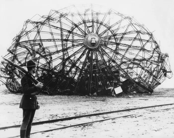 Framed Print : Hindenburg wreckage guarded by a soldier at the Naval Air Station in Lakehurst, NJ. May 1937. The German passenger airship's twisted metal skeleton remains Framed Print : Hindenburg wreckage guarded by a soldier at the Naval Air Station in Lakehurst, NJ. May 1937. The German passenger airship's twisted metal skeleton remains
