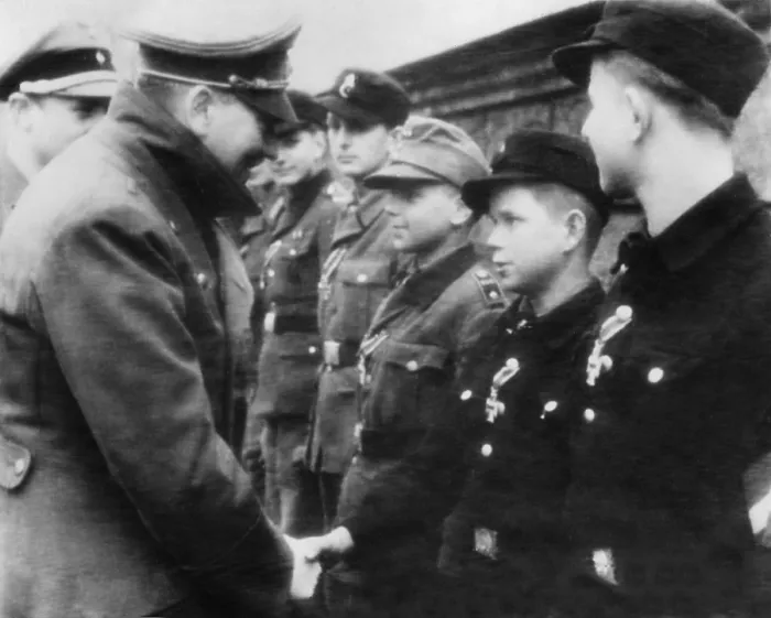 Framed Print : Hitler decorates a 12-year-old boy soldier with the iron Cross, second-class Framed Print : Hitler decorates a 12-year-old boy soldier with the iron Cross, second-class