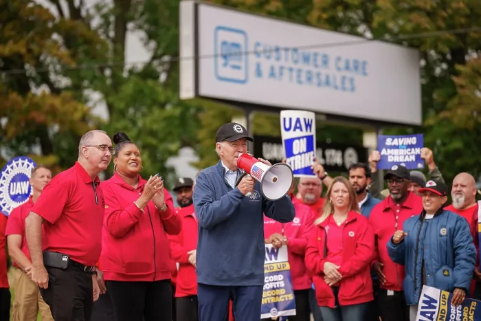 Framed Print : Holding a bullhorn, President Joe Biden addresses UAW members walking a picket line at the GM Willow Run Distribution Center, Sept. 26, 2023, in Belleville, Michigan