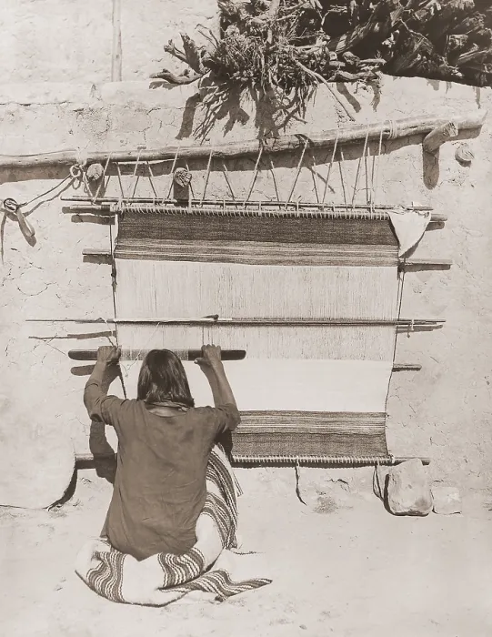 Framed Print : Hopi man weaving a blanket uses a wooden sley, a tool used in weaving to force the weft into place (BSLOC_2019_9_80)