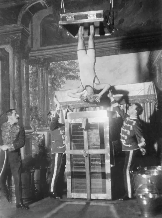 Framed Print : Houdini's Water Torture Cell escape. Houdini, with his ankles secured in stocks, was submerged and locked in place in full view of the audience. Ca. 1913 Framed Print : Houdini's Water Torture Cell escape. Houdini, with his ankles secured in stocks, was submerged and locked in place in full view of the audience. Ca. 1913