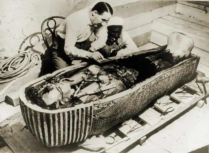 Framed Print : Howard Carter (1873-1939), seated beside coffin of King Tutankhamen, removing the consecration oils which covered the third or innermost coffin. 1926 Framed Print : Howard Carter (1873-1939), seated beside coffin of King Tutankhamen, removing the consecration oils which covered the third or innermost coffin. 1926