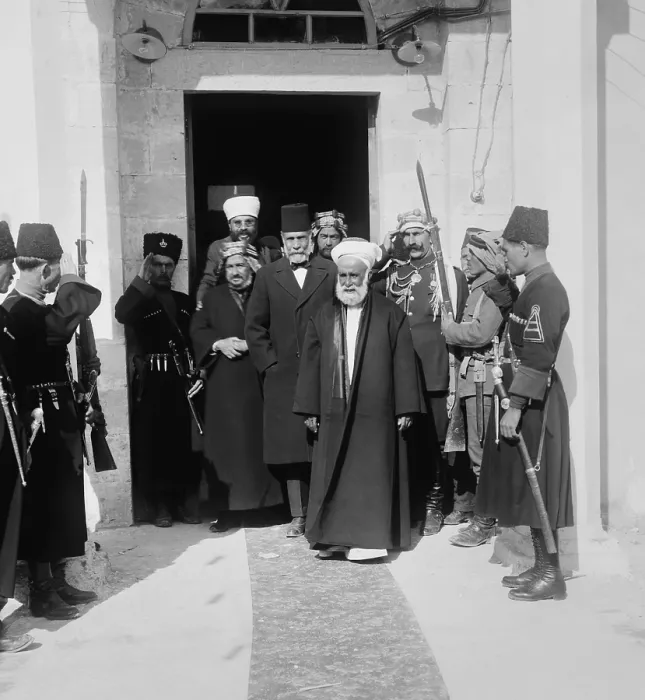 Framed Print : Hussein bin Ali, Sharif of Mecca, leads a group from a doorway, in Amman, Trans-Jordan, 1921 Framed Print : Hussein bin Ali, Sharif of Mecca, leads a group from a doorway, in Amman, Trans-Jordan, 1921