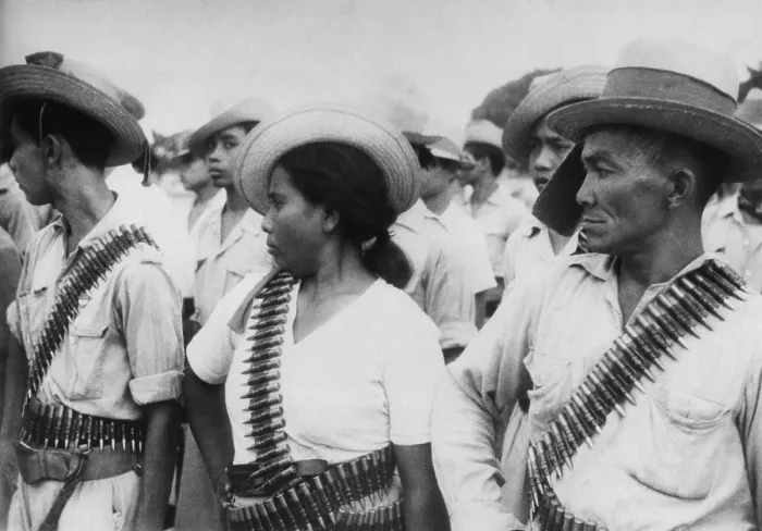 Framed Print : Indonesian peasant guerrillas wearing bandoliers. They are part of the non-uniformed combat personnel trained to support regular Indonesian military forces