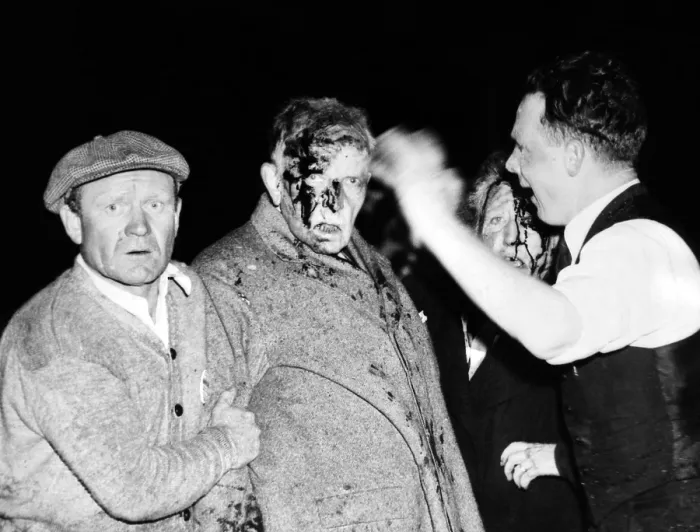 Framed Print : Injured in the Hindenburg Crash. Survivors are dazed and bloodied by the explosion, fire and crash, a man and women passenger are given first aid before going to the hospital