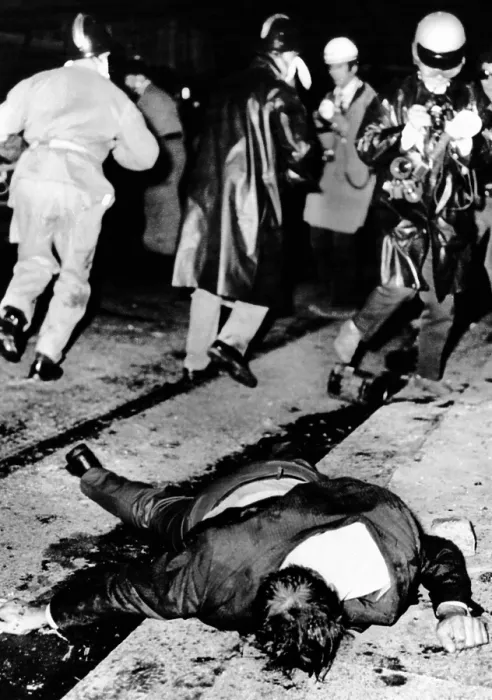 Framed Print : An injured man lies in the gutter as police battle rioting youths in Paris Latin Quarter. An estimated 6, 000 youths were involved in the clashes with police. May 23, 1969
