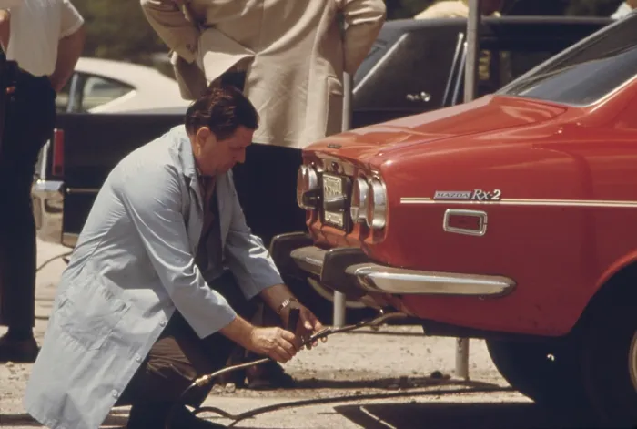 Framed Print : An inspector testing the exhaust of an automobile in Chicago a voluntary auto emissions testing program in 1973