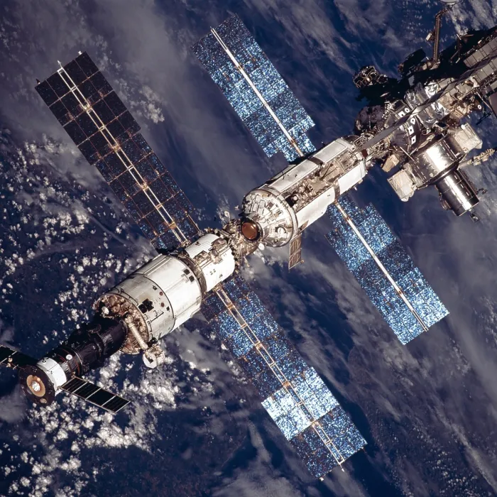 Framed Print : International Space Station in 2001. Overhead close-up view of the expanded International Space Station. At lower left a Russian Soyuz capsule is docked