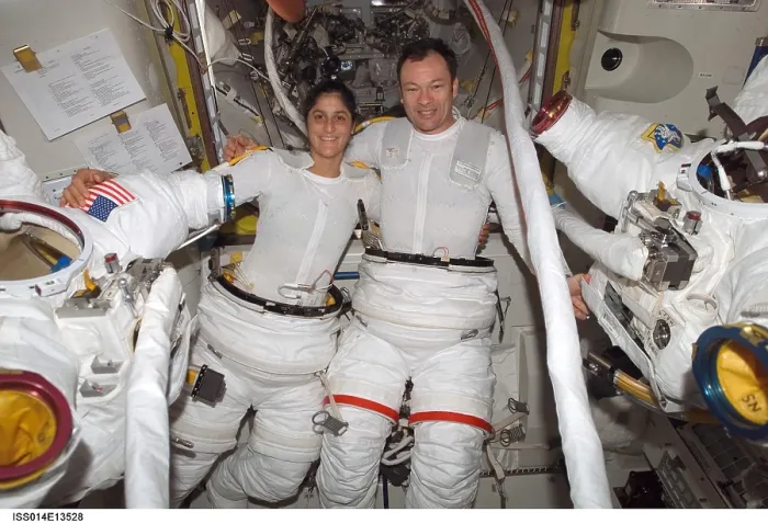 Framed Print : International Space Station activity. Astronauts Sunita Williams and Michael Lopez-Alegria, suit up before their spacewalk. July 18, 2008