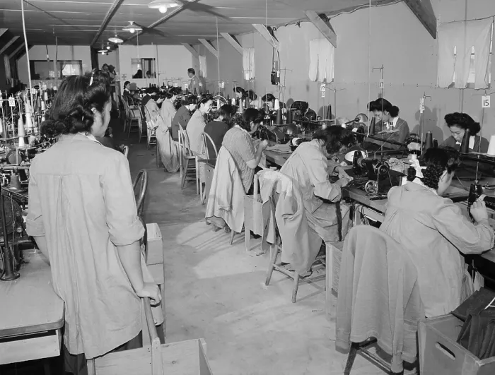 Framed Print : Interned Japanese American, Sumiko Shigematsu, standing at left, supervises fellow internees working at sewing machines at Manzanar Relocation Center, California