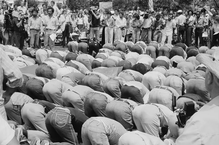 Framed Print : Iranian men bow in prayer during demonstration for Khomeini in Washington, D.C. during the 1979 Hostage Crisis. August 7, 1980