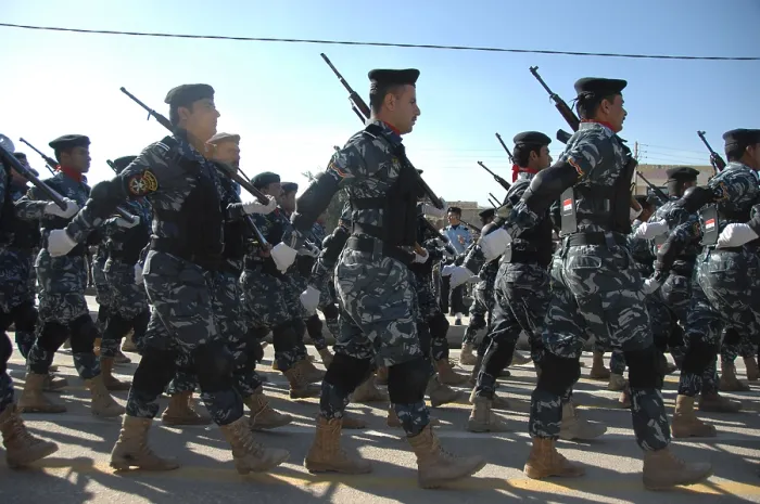 Framed Print : Iraqi police officers march during a parade in their honor near the in Nasiriyah Iraq. Jan. 9 2010. (BSLOC_2011_12_150)
