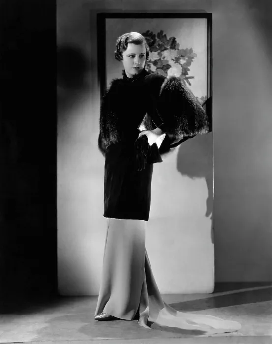 Framed Print : Irene Dunne, modeling a sapphire-velvet evening coat trimmed with silver fox, early 1930s