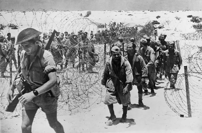 Framed Print : Italian and German prisoners of war captured in the El Alamein, Egypt. The are entering the cage preceded by their guard. Ca. 1942. (BSLOC_2013-12_74) Framed Print : Italian and German prisoners of war captured in the El Alamein, Egypt. The are entering the cage preceded by their guard. Ca. 1942. (BSLOC_2013-12_74)