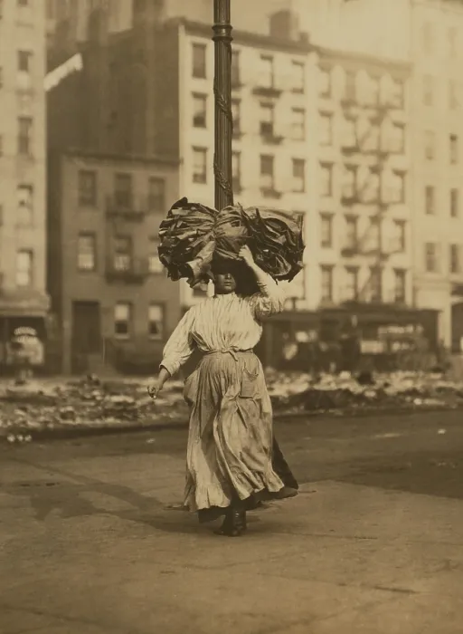 Framed Print : Italian woman carrying heavy bundle of clothing on her head Near Astor Place, New York City. She will sew the garments at home for low wages Framed Print : Italian woman carrying heavy bundle of clothing on her head Near Astor Place, New York City. She will sew the garments at home for low wages