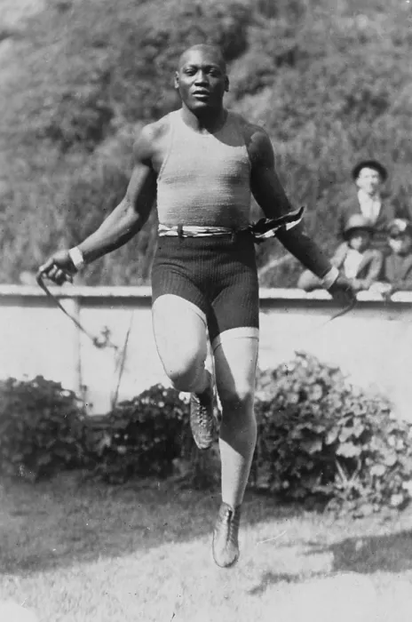 Framed Print : Jack Johnson (1878-1946) Heavyweight Championship of the World, with arms outstretched demonstrating his long reach. 1910. PROBLEM