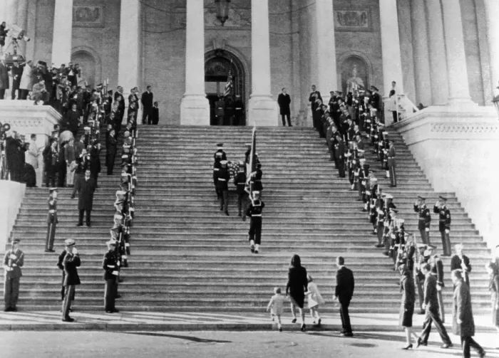 Framed Print : Jacqueline Kennedy escorts her children, Caroline and John, Jr. up the steps of the Capitol. They are following the casket of assassinated President John Kennedy