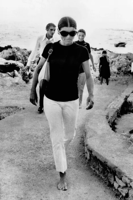 Framed Print : Jacqueline Kennedy Onassis on vacation in Capri, Italy. A barefooted Mrs. Jacqueline Onassis walks along the dock of this island resort. Behind her is her sister Lee Radziwill Framed Print : Jacqueline Kennedy Onassis on vacation in Capri, Italy. A barefooted Mrs. Jacqueline Onassis walks along the dock of this island resort. Behind her is her sister Lee Radziwill