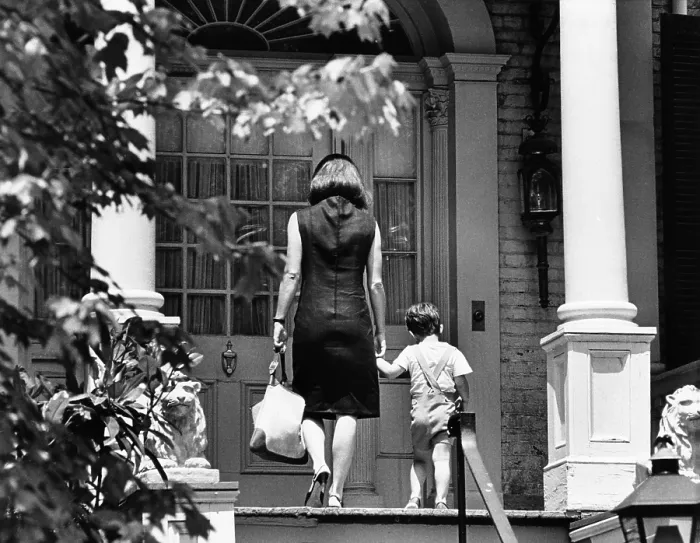 Framed Print : Jacqueline Kennedy and her son, 3 year old John F, Kennedy Jr. entering their Georgetown Federal era home