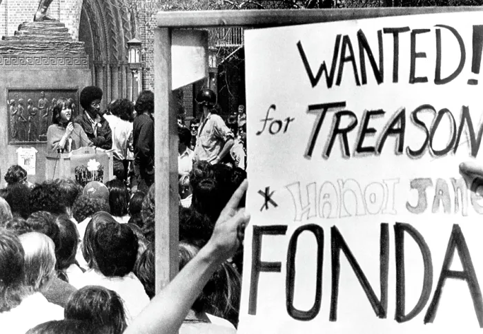 Framed Print : Jane Fonda (left), students holding anti-Jane Fonda sign while Fonda addresses students on the campus of Univ. of Southern California, Los Angeles, April 12, 1973 Framed Print : Jane Fonda (left), students holding anti-Jane Fonda sign while Fonda addresses students on the campus of Univ. of Southern California, Los Angeles, April 12, 1973