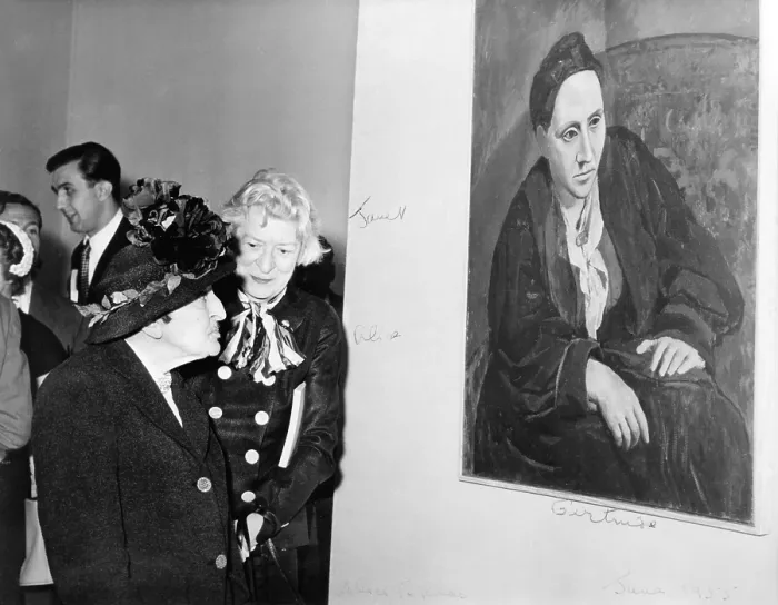 Framed Print : Janet Flanner (1892-1978) standing with Alice B. Toklas (1877-1967) in front of Picasso's portrait of Gertrude Stein (1874-1946). 1955. Image has fine art copyright