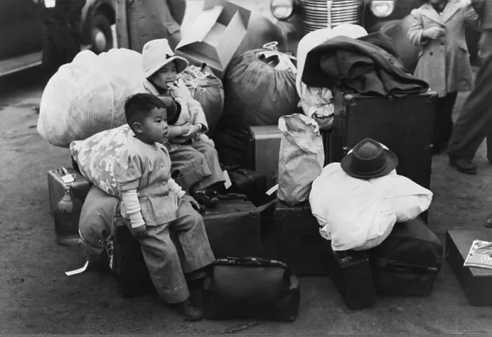 Framed Print : Japanese American children sit among their family's belongings as they wait for transportation to Owens Valley Assembly center for internment during World War II