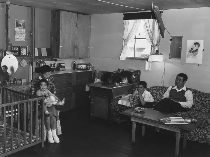 Framed Print : Japanese American family interned at Manzanar Relocation Center during World War II. Mr. & Mrs. Richard Izuno and their two children pose a one-room (approx)