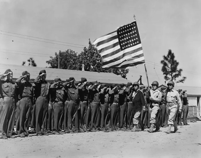 Framed Print : Japanese-American soldiers salute their country's flag on their arrival at Camp Shelby