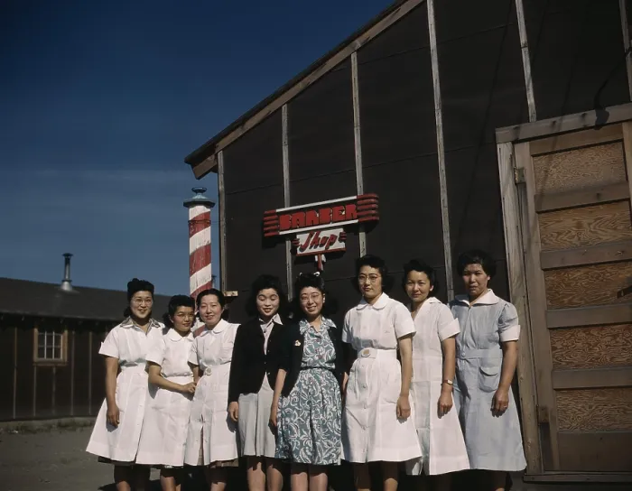Framed Print : Eight Japanese American women pose for a photograph in front of a camp barber shop of Tule Lake Relocation Center, the largest