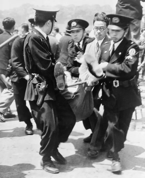 Framed Print : Japanese police hauling away a demonstrator during the 4th anniversary constitution day ceremony at the Imperial Palace plaza, Tokyo, Japan. 1951