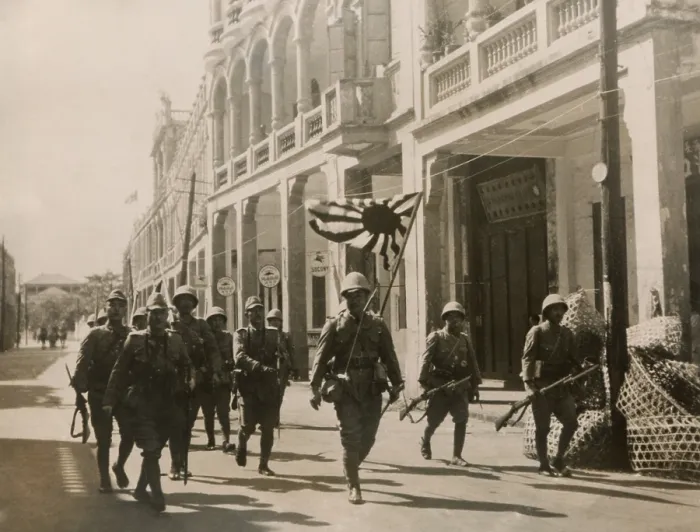 Framed Print : Japanese troops march in the streets of Hainan Island with a Rising Sun flag. May 3, 1939