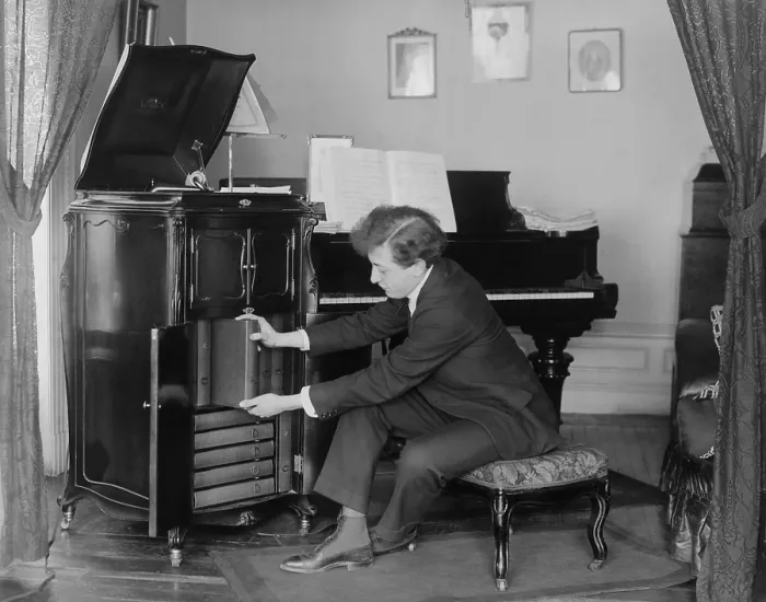 Framed Print : Jascha Heifetz, 17 year old violin virtuoso removing a record album from his Victrola phonograph, c. 1917 (BSLOC_2017_12_35) Framed Print : Jascha Heifetz, 17 year old violin virtuoso removing a record album from his Victrola phonograph, c. 1917 (BSLOC_2017_12_35)
