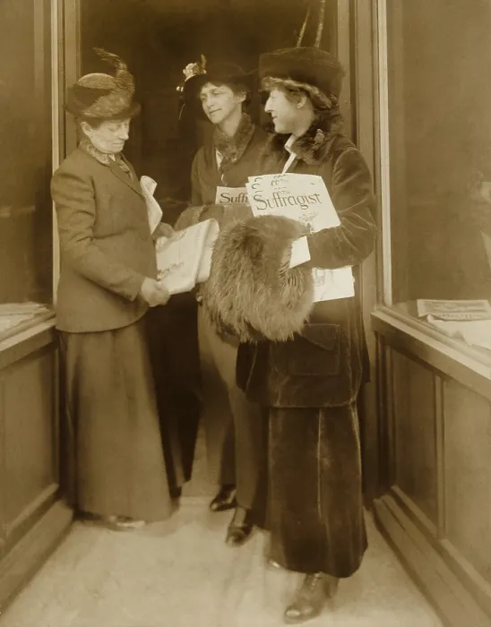 Framed Print : Jeanette Rankin, with hat, fur muff, and several issues of THE SUFFRAGIST, the magazine of the militant National Women's Party with two women Framed Print : Jeanette Rankin, with hat, fur muff, and several issues of THE SUFFRAGIST, the magazine of the militant National Women's Party with two women