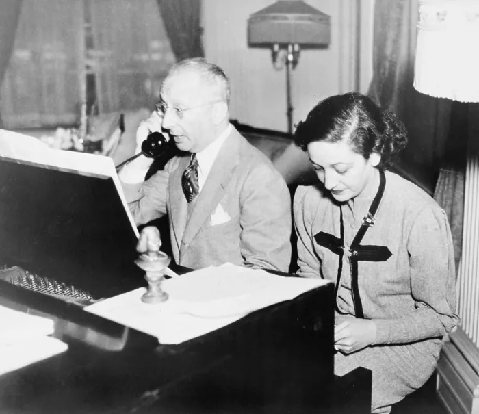 Framed Print : Jerome Kern (1885-1945), talking on the telephone while his lyricist, Dorothy Fields (1905-1974), works at the piano, 1945 Framed Print : Jerome Kern (1885-1945), talking on the telephone while his lyricist, Dorothy Fields (1905-1974), works at the piano, 1945