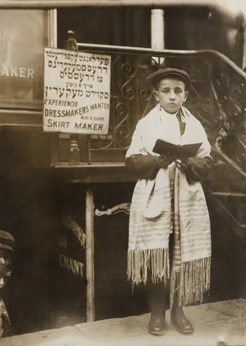 Framed Print : Jewish boy wearing a prayer shawl and boy reading from a Hebrew Bible on Yom Kippur, on a New York City street in a Jewish neighborhood. Ca.1911