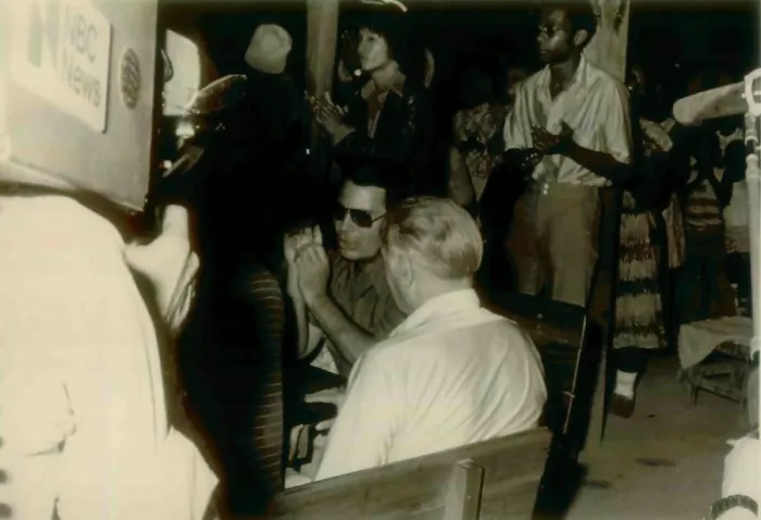 Framed Print : Jim Jones sitting with fact finding guests as an NBC cameraman records their conversation. In center maybe Congressman Leo Ryan. People's Temple Agricultural Project