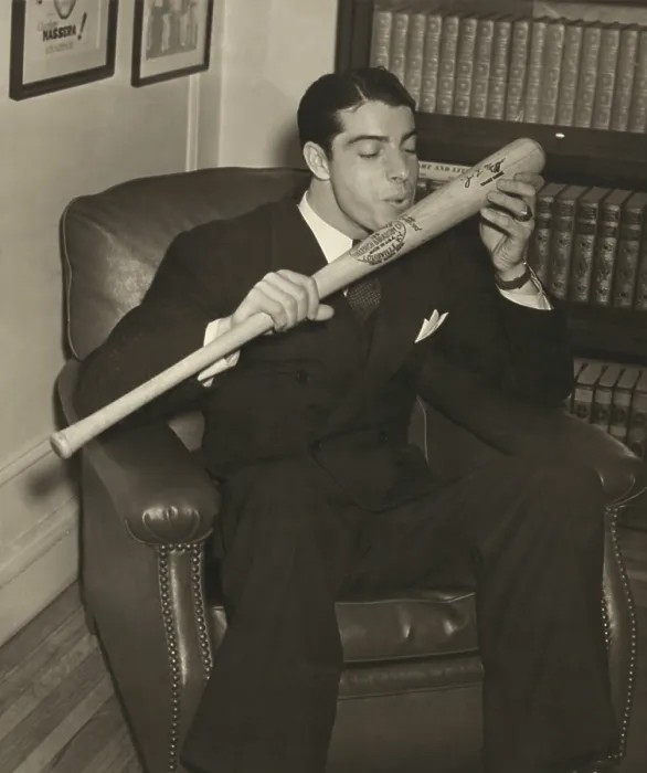 Framed Print : Joe DiMaggio, of the New York Yankees, kisses his signature baseball bat, Dec. 1941. DiMaggios 1941 record for a 56-game hitting streak still stands (BSLOC_2018_3_191)