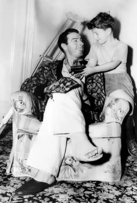 Framed Print : Joe DiMaggio, recovering from an operation on his right heel, shows his son Joe jr. a stauette given to him as a gift by the Rome Athletic Club in Italy. ca. December 1948 Framed Print : Joe DiMaggio, recovering from an operation on his right heel, shows his son Joe jr. a stauette given to him as a gift by the Rome Athletic Club in Italy. ca. December 1948