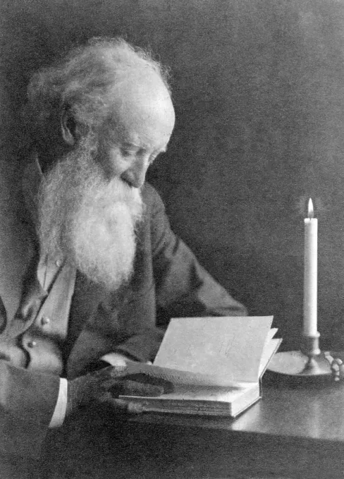Framed Print : John Burroughs (1837-1921), American naturalist author reading by candlelight. Ca. 1910