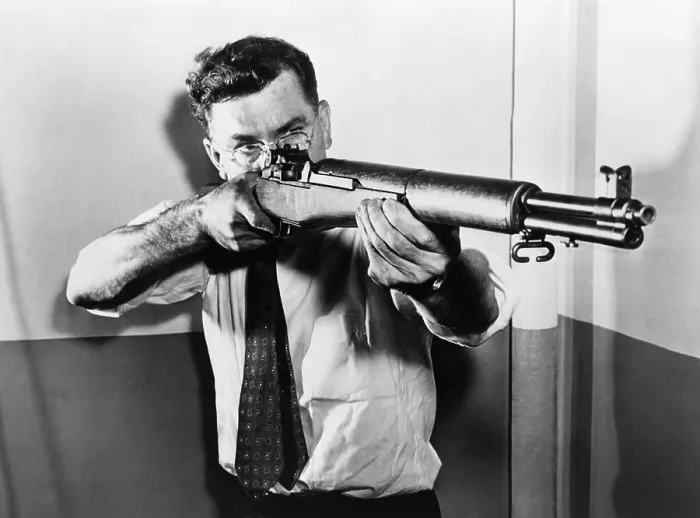 Framed Print : John C. Garand (1888-1974), aiming one of the semi-automatic U.S. rifles, the.30 caliber M 1, he invented. The M1 semiautomatic rifle, was used by U.S Framed Print : John C. Garand (1888-1974), aiming one of the semi-automatic U.S. rifles, the.30 caliber M 1, he invented. The M1 semiautomatic rifle, was used by U.S