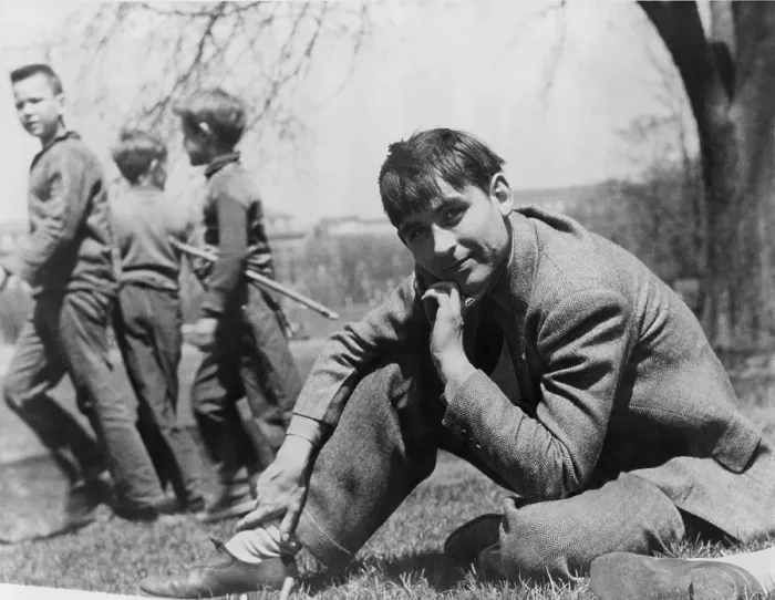Framed Print : John Collier, Jr. (b. 1913), American photographer with the Farm Security Administration, seated on lawn with boys in the background. 1943 Framed Print : John Collier, Jr. (b. 1913), American photographer with the Farm Security Administration, seated on lawn with boys in the background. 1943