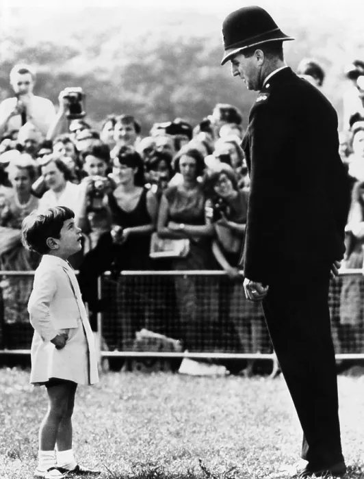 Framed Print : John F. Kennedy Jr. looks up at a British policeman during dedication ceremonies of a memorial to the late President Kennedy, at Runnymede, England. May 14, 1965 Framed Print : John F. Kennedy Jr. looks up at a British policeman during dedication ceremonies of a memorial to the late President Kennedy, at Runnymede, England. May 14, 1965
