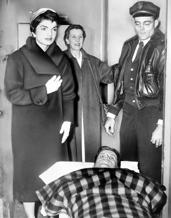Framed Print : John F. Kennedy leaving on gurney from hospital following spinal surgery, as his wife Jacqueline stands over him. Photo by Dick DeMarsico December 21, 1954