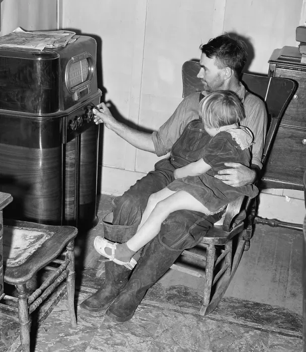 Framed Print : John Frost and daughter listening to their radio, a luxury item in their modest home for a family of seven